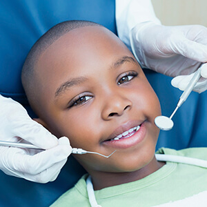Young boy being examined in dental chair