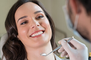 Woman smiling jovially in dental chair