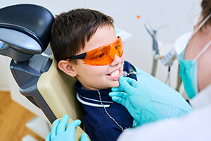 young boy with sports shades examined by dentist