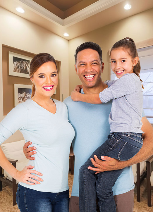 Family of three beaming in dental office