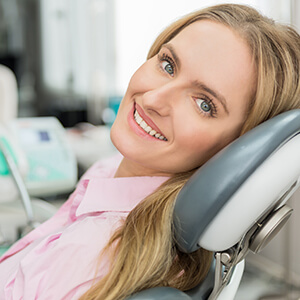 lady on reclined dental chair grinning