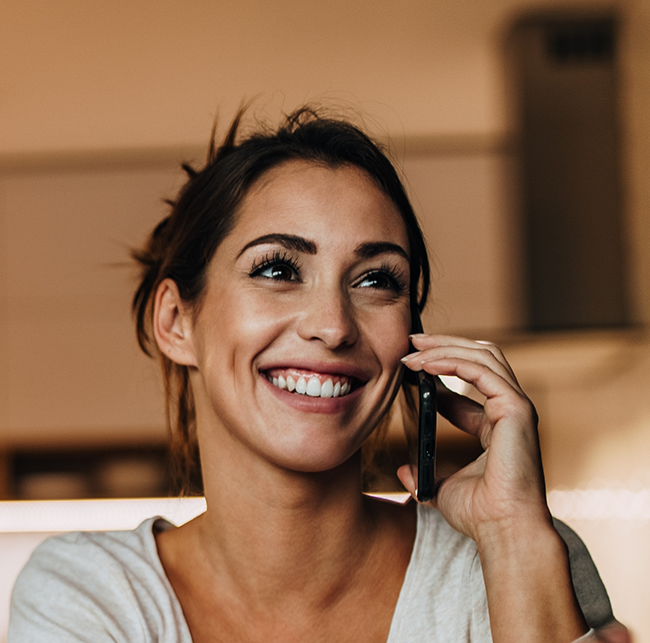 Woman talking on the phone with a dental office in Sparks
