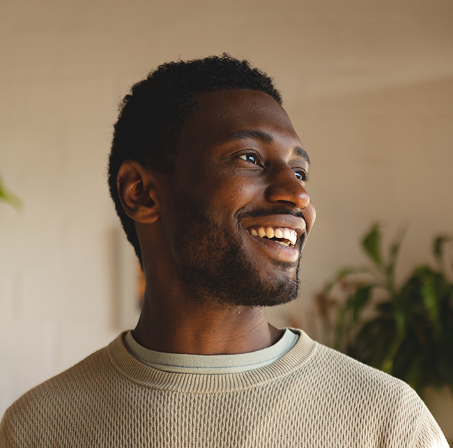 Man smiling indoors with a dental bridge in Sparks