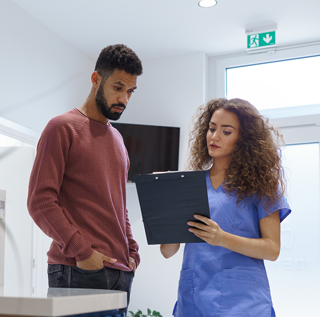 Dental team member showing a clipboard to a patient