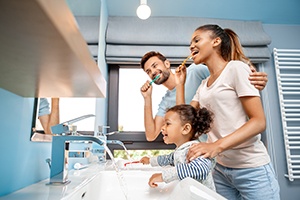 a family brushing their teeth together