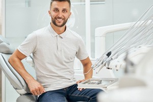 Man sitting in dental chair and smiling