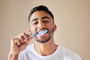 Close-up of bearded man brushing his teeth