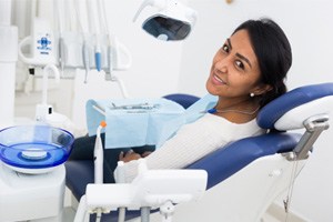 Woman in dental chair looking back and smiling