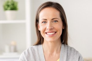 Close-up of woman in grey shirt smiling