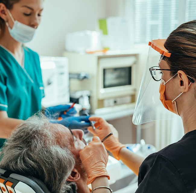 Dental team member treating a patient