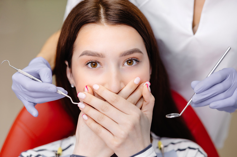 Patient covering their mouth afraid of cosmetic dentistry